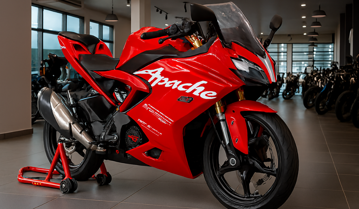 TVS Apache RR 310 sport bike in red displayed inside a premium motorcycle showroom, showcasing aerodynamic fairing, dual LED headlamps, split seat design, and racing paddock stand—ideal for enthusiasts exploring Apache RR 310 price, specs, and performance in India.